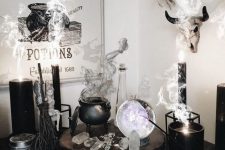 08 a chic witch’s nook with a cauldron with smoke, candles, crystals, a sphere and some signs is a gorgeous idea for Halloween