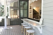 16 a neutral farmhouse space with a folding pass through window, a floating dining table and rattan stools is a lovely idea to go for