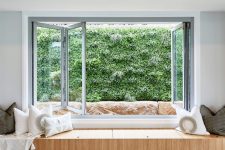 21 a folding window with a built-in storage daybed with lots of pillows and a greenery view is a gorgeous idea for a modern space