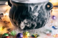 21 a lovely Halloween decoration of a black cauldron with smoke and lots of sweets around is easy to make and looks cool