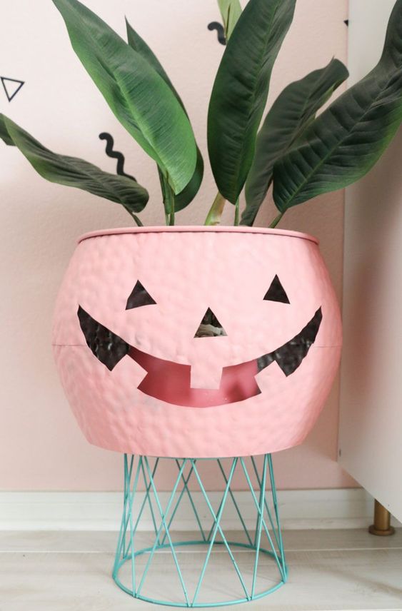 A pink jack o lantern cauldron is a lovely cover for a planter or a bowl to serve something and it will do for many Halloween parties