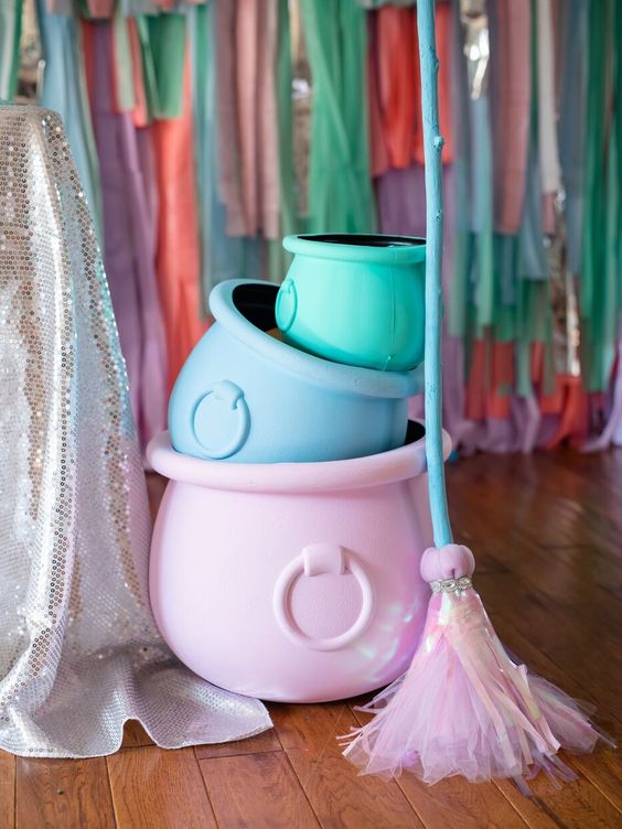 pastel-colored cauldrons and a broom fro styling a fun adult or a sweet kids' Halloween party