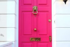 a bold fuchsia front door with vintage refined detailing is a cool idea to make a color statement at once and refresh the entrance with color