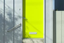 a contemporary front door painted neon yellow and with a house number is ultimate idea to make a bold statement with color