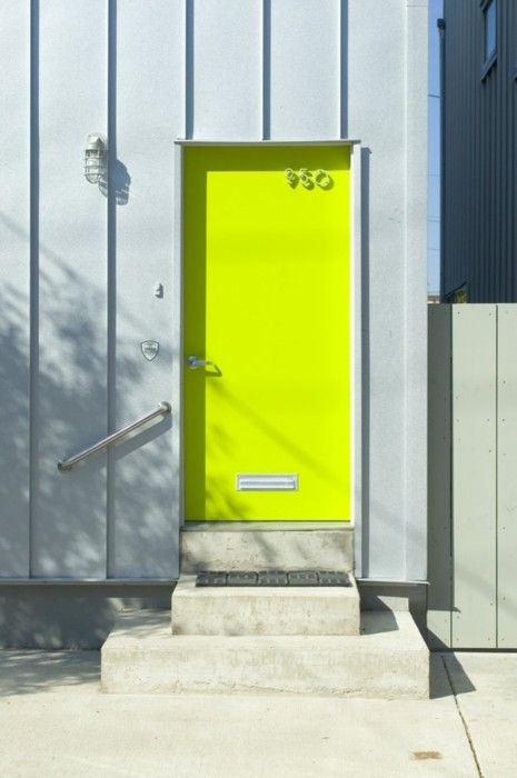 a contemporary front door painted neon yellow and with a house number is ultimate idea to make a bold statement with color