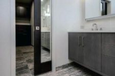 a dark-stained and mirror pocket door to the bathroom is a cool alternative to a usual door and a mirror at the same time