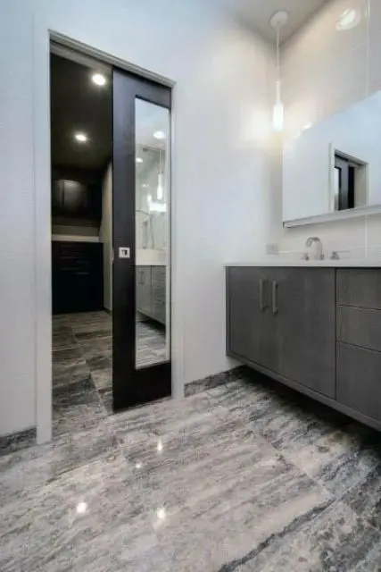 A dark stained and mirror pocket door to the bathroom is a cool alternative to a usual door and a mirror at the same time