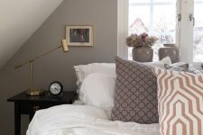 a smart attic bedroom design in neutral tones