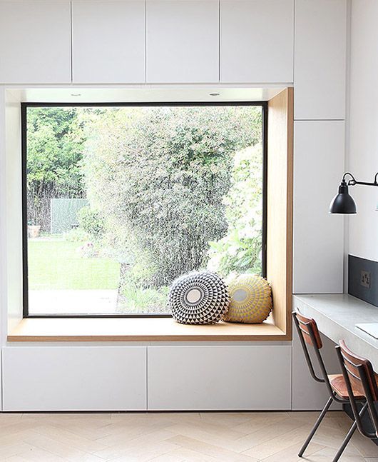 a minimalist windowsill reading nook with drawers for storage under it - you can store your books there