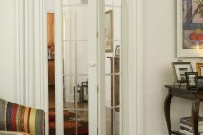 a mirror framed folding door is a lovely idea to separate the spaces from each other and even a small space doesn’t look smaller with such a door