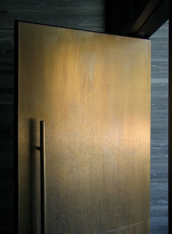 a modern weathered metal front door is a chic and bold statement in an unexpected color, choose it for a modern home