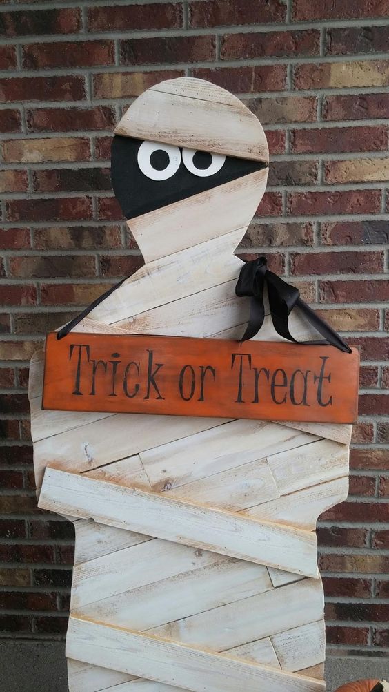 a plywood mummy is a very lon-lasting decoration that you can easily make, add a sign and a crate with sweets and candies