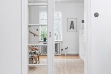a white French pocket door separates the room and makes both spaces light-filled at the same time