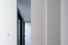 a white pocket door looks very sleek and chic and doesn’t stand out from the rest of the room looking cool