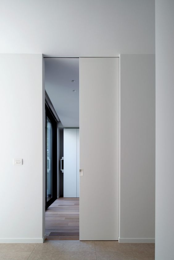 a white pocket door looks very sleek and chic and doesn't stand out from the rest of the room looking cool