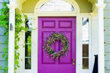 accent your entrance with a bold purple front door to make a statement with the color, even if the design of the door is very simple