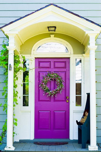 accent your entrance with a bold purple front door to make a statement with the color, even if the design of the door is very simple
