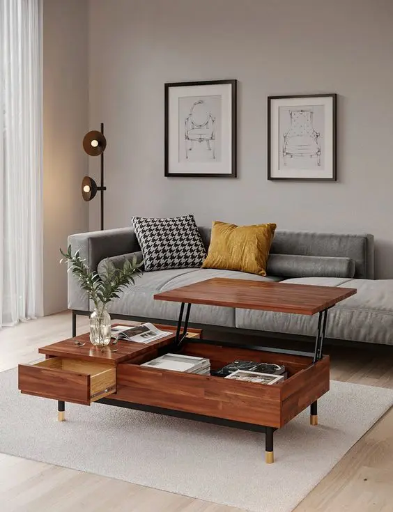 An elegant greige mid century modern living room with a grey couch, a mini gallery wall, a pretty coffee table with a raising tabletop