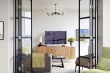 black frame and glass folding doors delicately separate the spaces and accent the decor a lot while letting light in and out