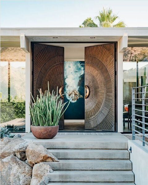 Fantastic oversized metal front doors with a pattern is a gorgeous solution for a mid century modern or modern house
