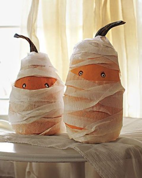 fun gourds styled as mummies with googly eyes are a cool craft for a kids' Halloween party and you cna make them together
