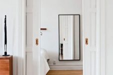 refined white paned pocket doors are a perfect way to divide the spaces in a stylish way and save a lot of room