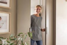 sleek and chic dove grey pocket doors wiht little handles are ideal to delicately separate the spaces without stealing room