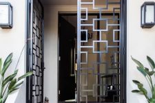 wrought metal and glass doors look modern and bold and geometry gives a nice touch to the entrance