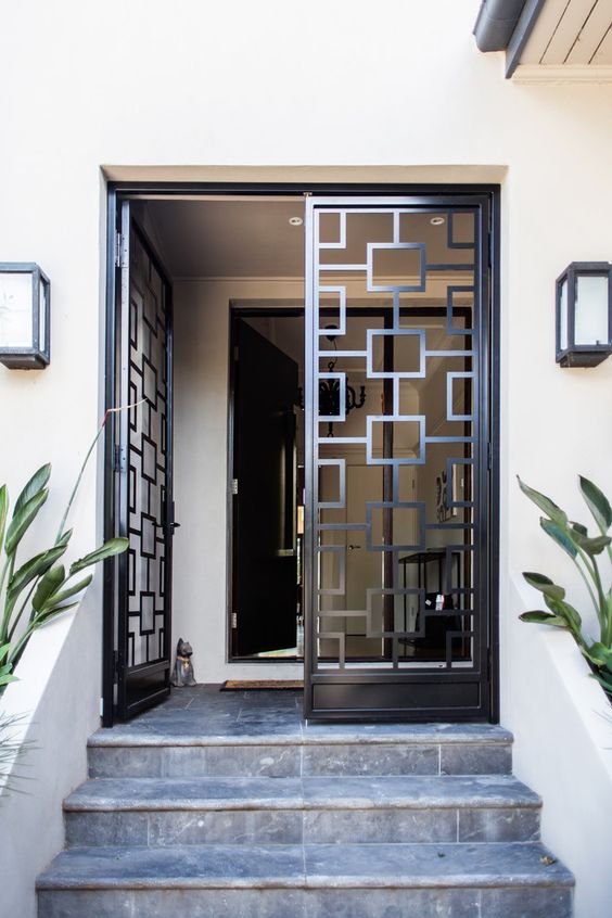 wrought metal and glass doors look modern and bold and geometry gives a nice touch to the entrance