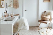 11 a neutral boho home office with a white desk and chair, a mini gallery wall, a boho wall hanging and layered rugs