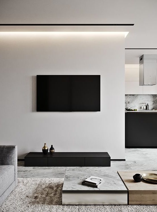a contrasting living room in off-white and black, laconic coffee tables, a textural rug and built-in lights