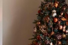 08 a bold woodland glam Christmas tree with copper and brown ornaments, sequin pinecones, lights, leaves and owls hanging
