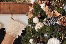 10 a Christmas tree with lights, brown, silver and white ornaments, wooden beads, snowy pinecones, cotton and bells is a great idea for both a rustic or a forest celebration