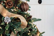 19 a gorgeous rustic and woodland glam Christmas tree with usual and snowy pinecone ornaments, fabric balls, lights, brown and gold glitter ribbons is wow