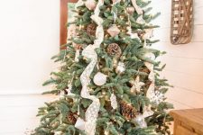 23 a lovely rustic or woodland Christmas tree with lace ribbons, pinecones, white ornaments, lights and animal-shaped figurines