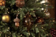 25 a cool forest Christmas tree with vintage brown, gold and beige ornaments shaped as balls, deer printed balls, acorns and pinecones is amazing