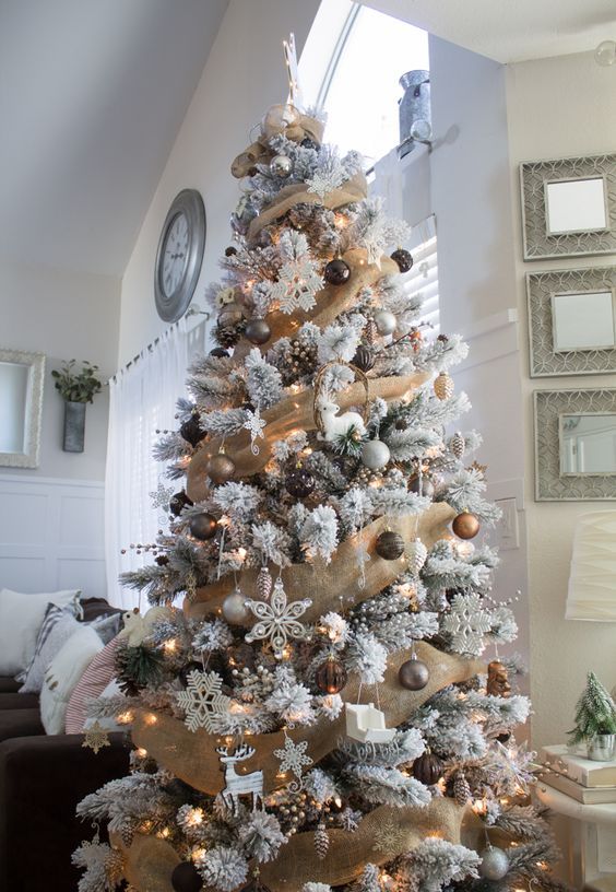 a glam woodland Christmas tree with burlap garlands, gold, brown, grey ornaments, snowflakes, deer and sleigh ornaments