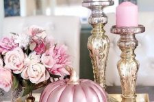 27 glam Thanksgiving decor with a pink metallic pumpkin, pink candles in shiny candleholders and pink blooms is amazing
