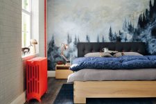 a pretty and welcoming bedroom with an artwork that takes a whole wall, modern furniture, a hot red radiator and a navy rug