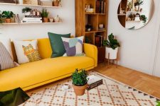a cozy living room with a bold yellow sofa