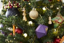 06 a bright Harry Potter Christmas tree decorated with faceted purple ornaments, cauldrons, chess, owls, lights and other stuff is wow