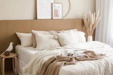 06 a neutral boho bedroom with a terracotta accent, a pendant lamp, woven baskets, layered bedding