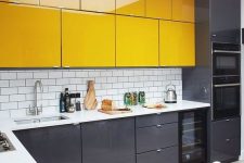 08 a minimalist kitchen with black lower cabinets and bright yellow upper ones plus white countertops is ultimately bold