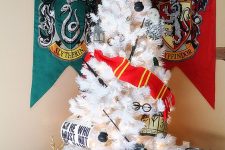09 a white Harry Potter Christmas tree decorated with glasses, a Griffindor scarf, wands and cauldrons plus a Sorting Hat topper