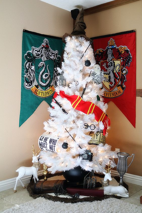 a white Harry Potter Christmas tree decorated with glasses, a Griffindor scarf, wands and cauldrons plus a Sorting Hat topper