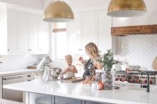 12 these amazing gold pendant lamps over the kitchen island highlight the style of the space and add glam and chic to it