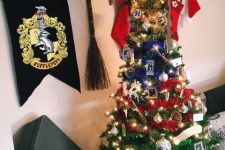 13 a bright Christmas tree decorated with photos, platform numbers, lights, colorful garlands and a Sorting Hat tree topper