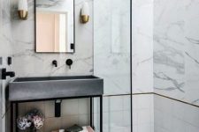 15 a glam bathroom clad with white marble, with tiles, a concrete sink and black fixtures to give it a fresher modern feel