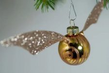 16 a lovely Golden Snitch ornament with a pattern and beautiful gold glitter wings is a pretty decoration for your tree