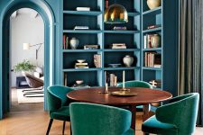 24 a fabulous stone blue dining space with built-in shelves and storage units, a stained dining table, teal chairs and a pendant lamp
